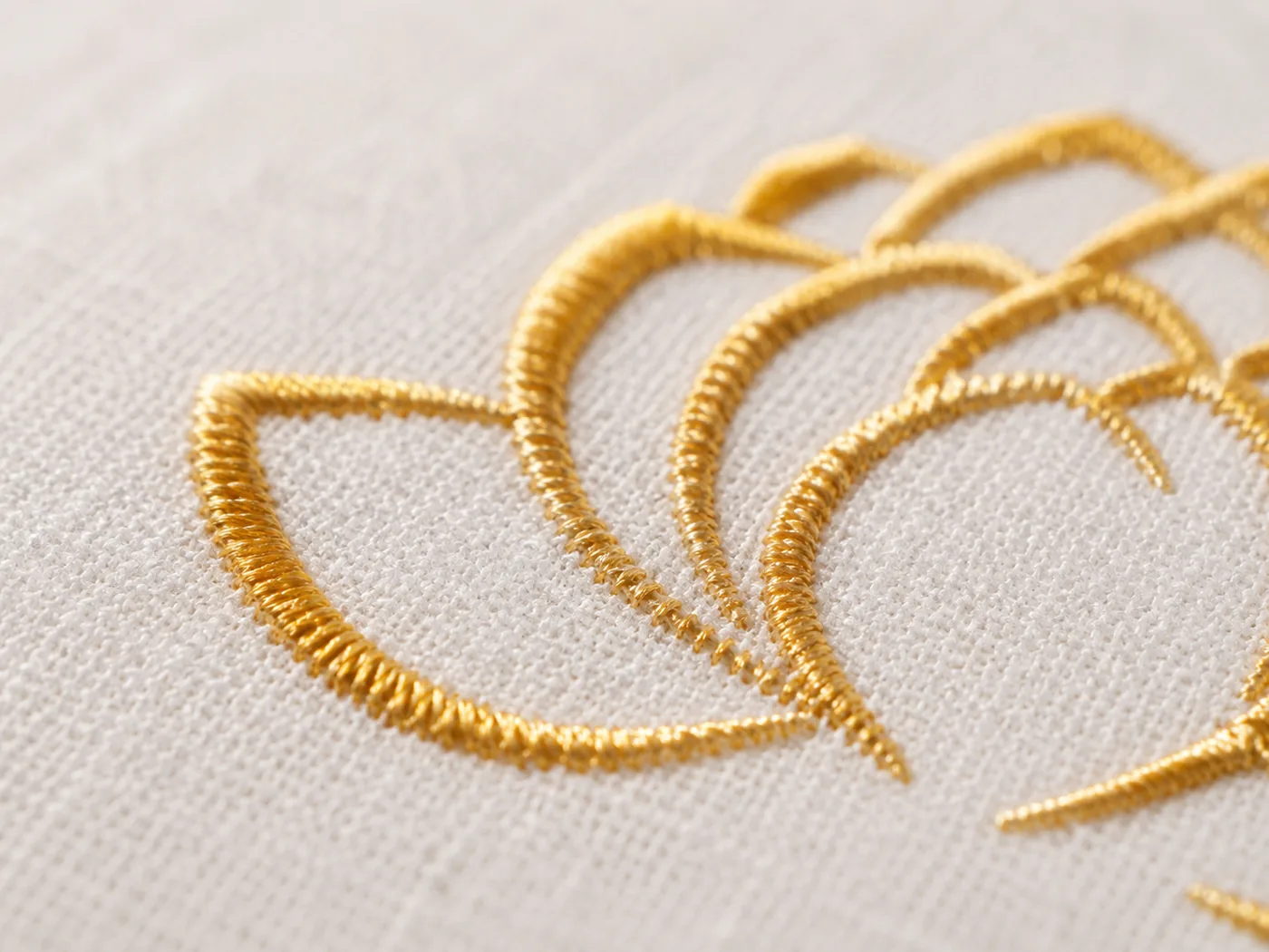 A close-up of the gold lotus embroidery on the linen cover, matching what buyers show in their photos